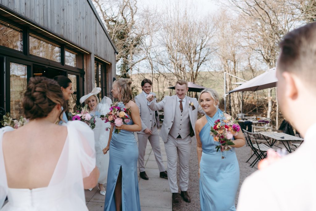 Beth & Rob's wedding at Carwinley Barn, Cumbria — drinks, confetti, everyone talking at once