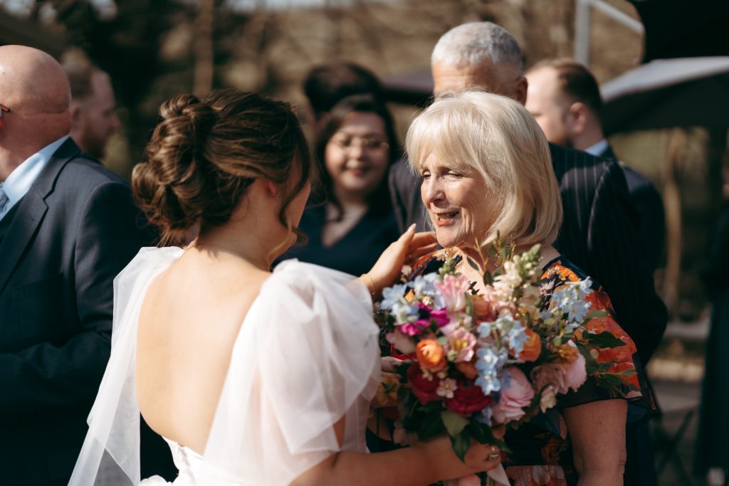 Beth & Rob's wedding at Carwinley Barn, Cumbria — drinks, confetti, everyone talking at once
