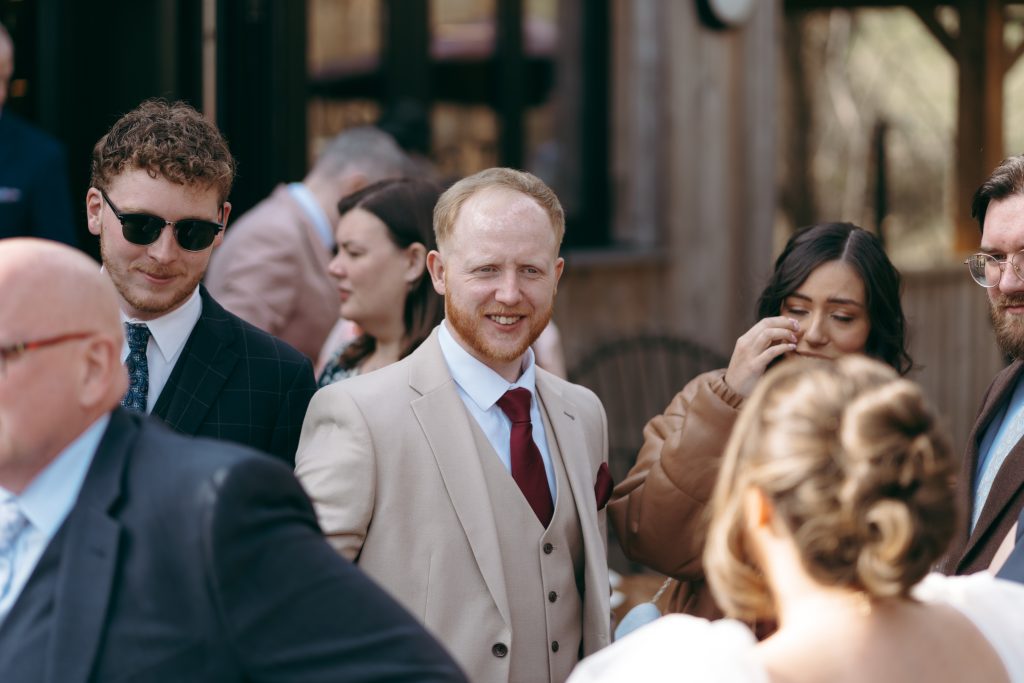 Beth & Rob's wedding at Carwinley Barn, Cumbria — drinks, confetti, everyone talking at once