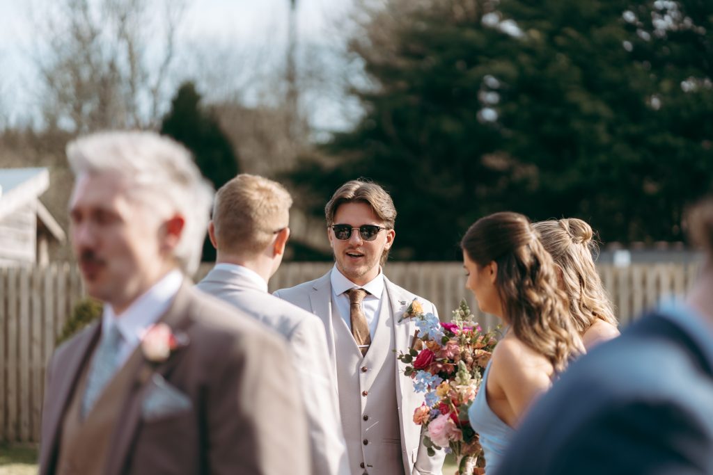 Beth & Rob's wedding at Carwinley Barn, Cumbria — drinks, confetti, everyone talking at once