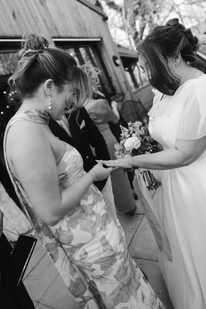 Beth & Rob's wedding at Carwinley Barn, Cumbria — drinks, confetti, everyone talking at once