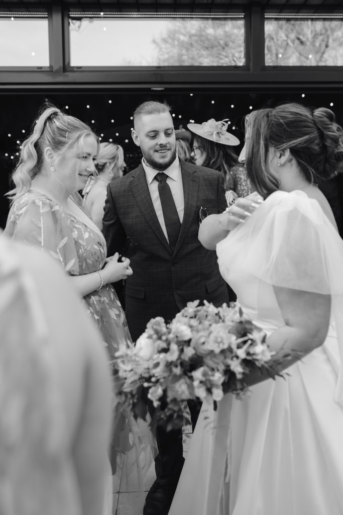 Beth & Rob's wedding at Carwinley Barn, Cumbria — drinks, confetti, everyone talking at once