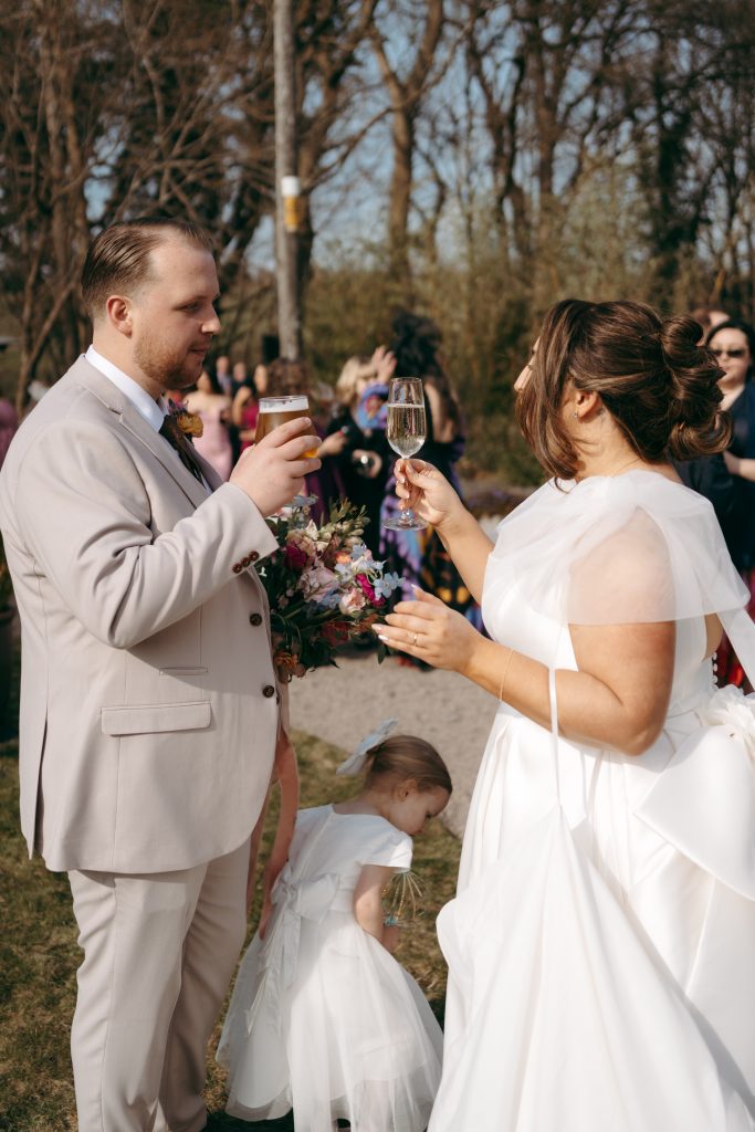 Beth & Rob's wedding at Carwinley Barn, Cumbria — drinks, confetti, everyone talking at once