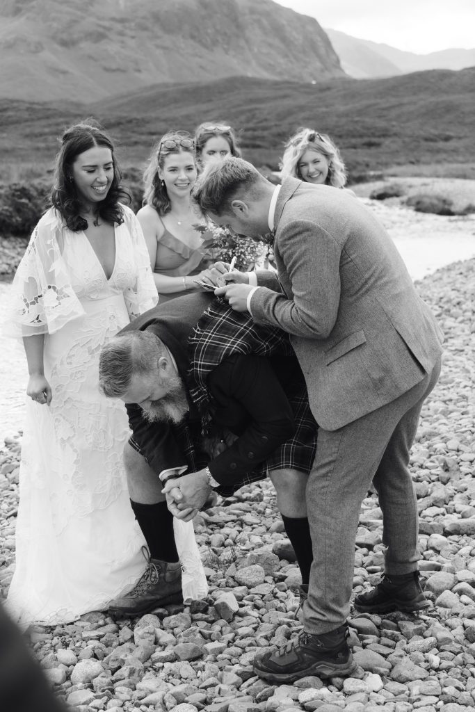 Mike & Hev's wedding at The Wee White House, Glencoe — drinks, confetti, everyone talking at once