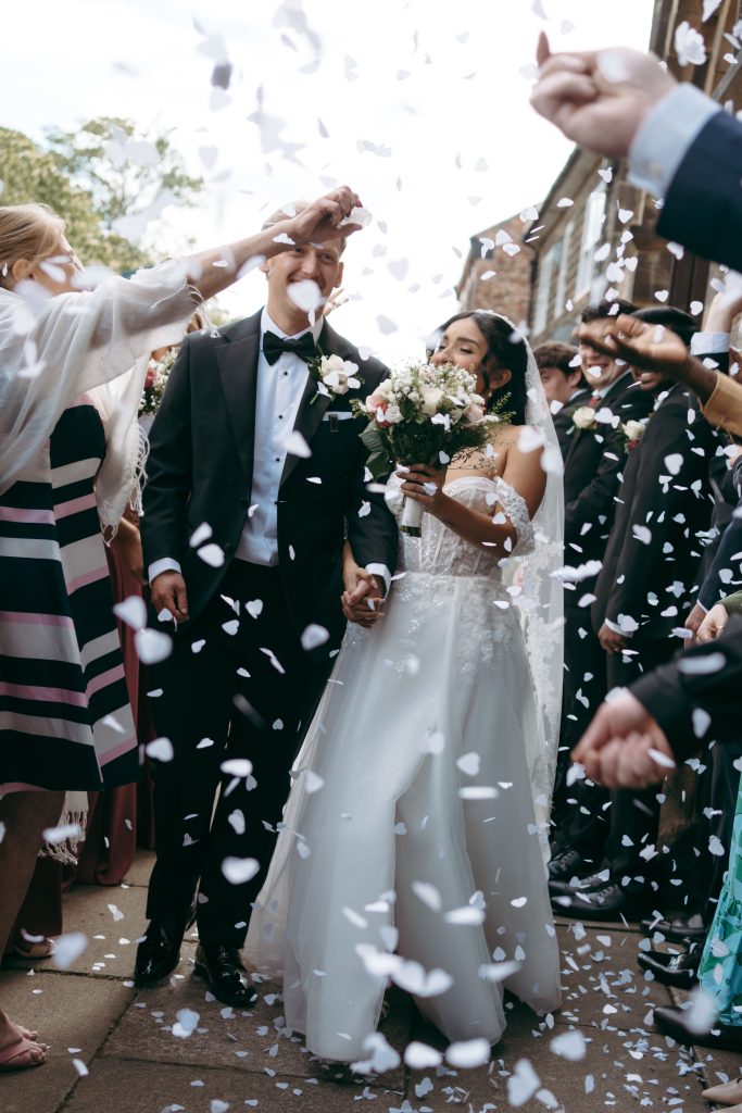 Monique & Taylor's wedding at Teeside Vineyard Church — drinks, confetti, everyone talking at once