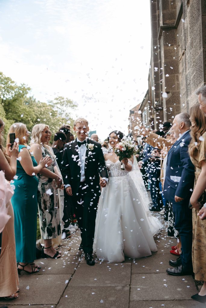 Monique & Taylor's wedding at Teeside Vineyard Church — drinks, confetti, everyone talking at once