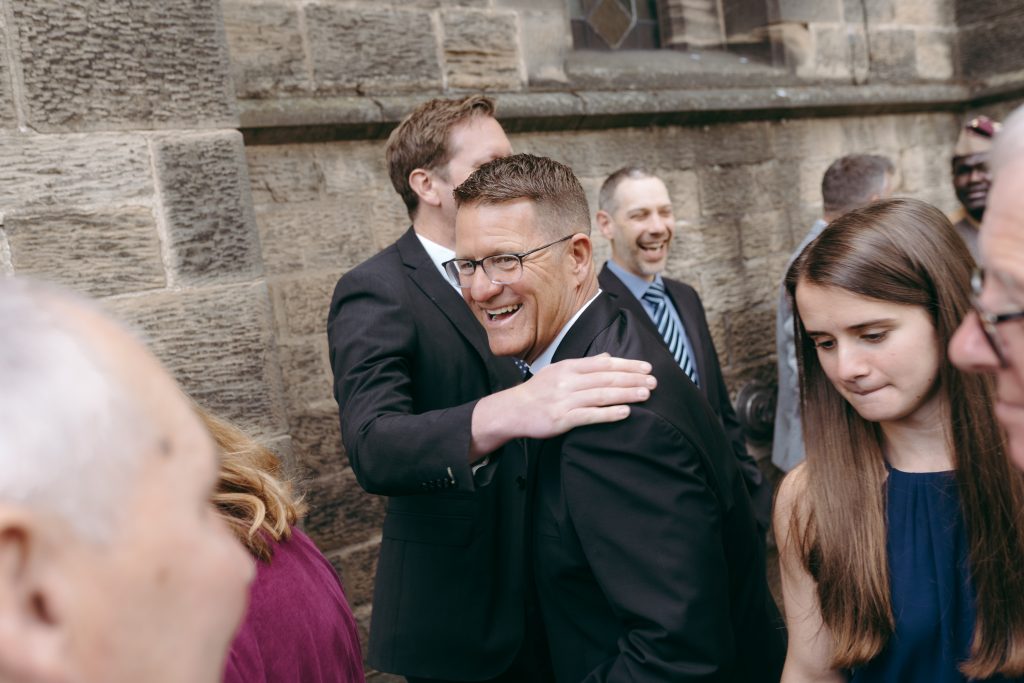 Monique & Taylor's wedding at Teeside Vineyard Church — drinks, confetti, everyone talking at once